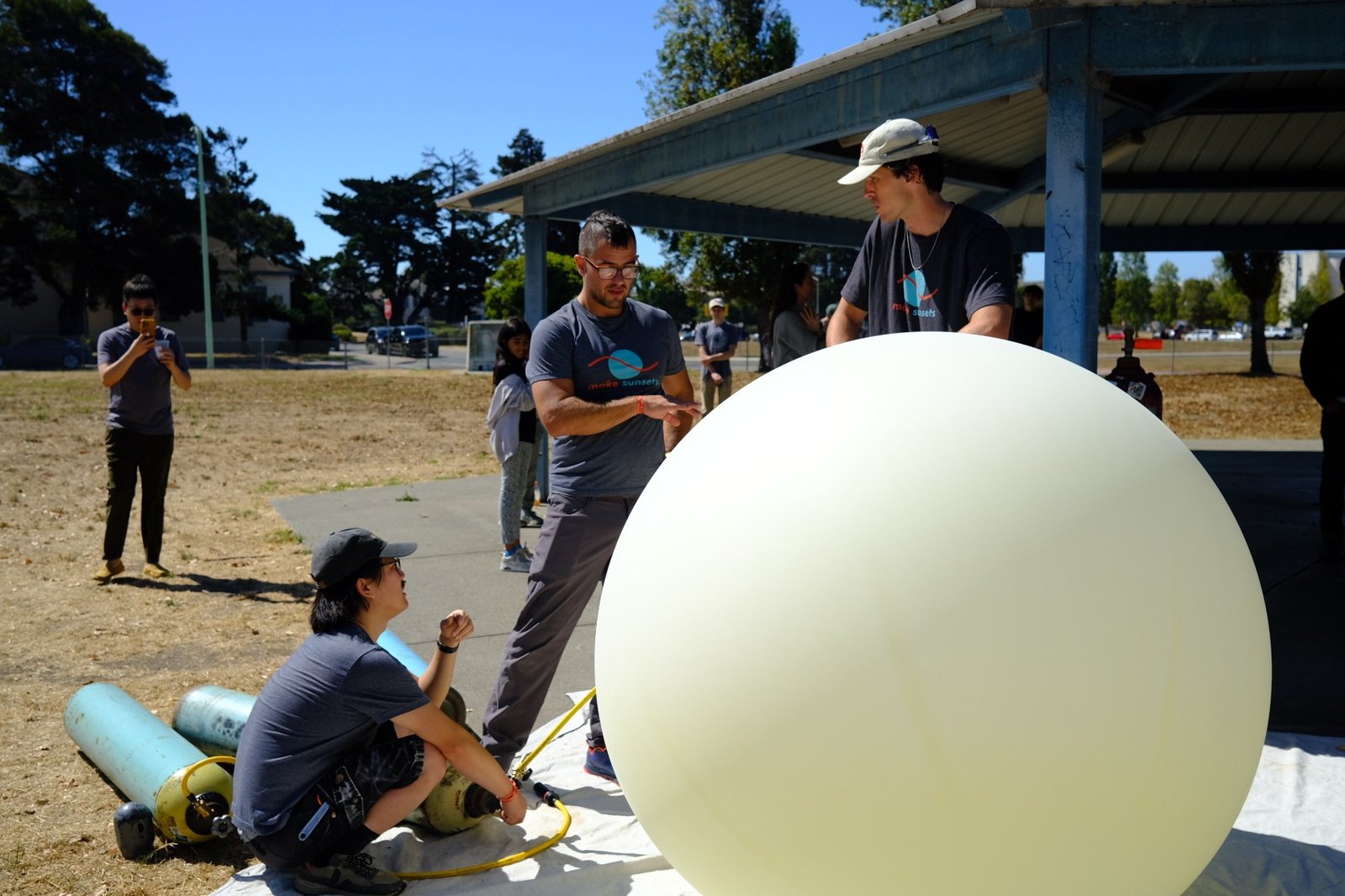 Make Sunsets team filling a balloon with an artificial cloud